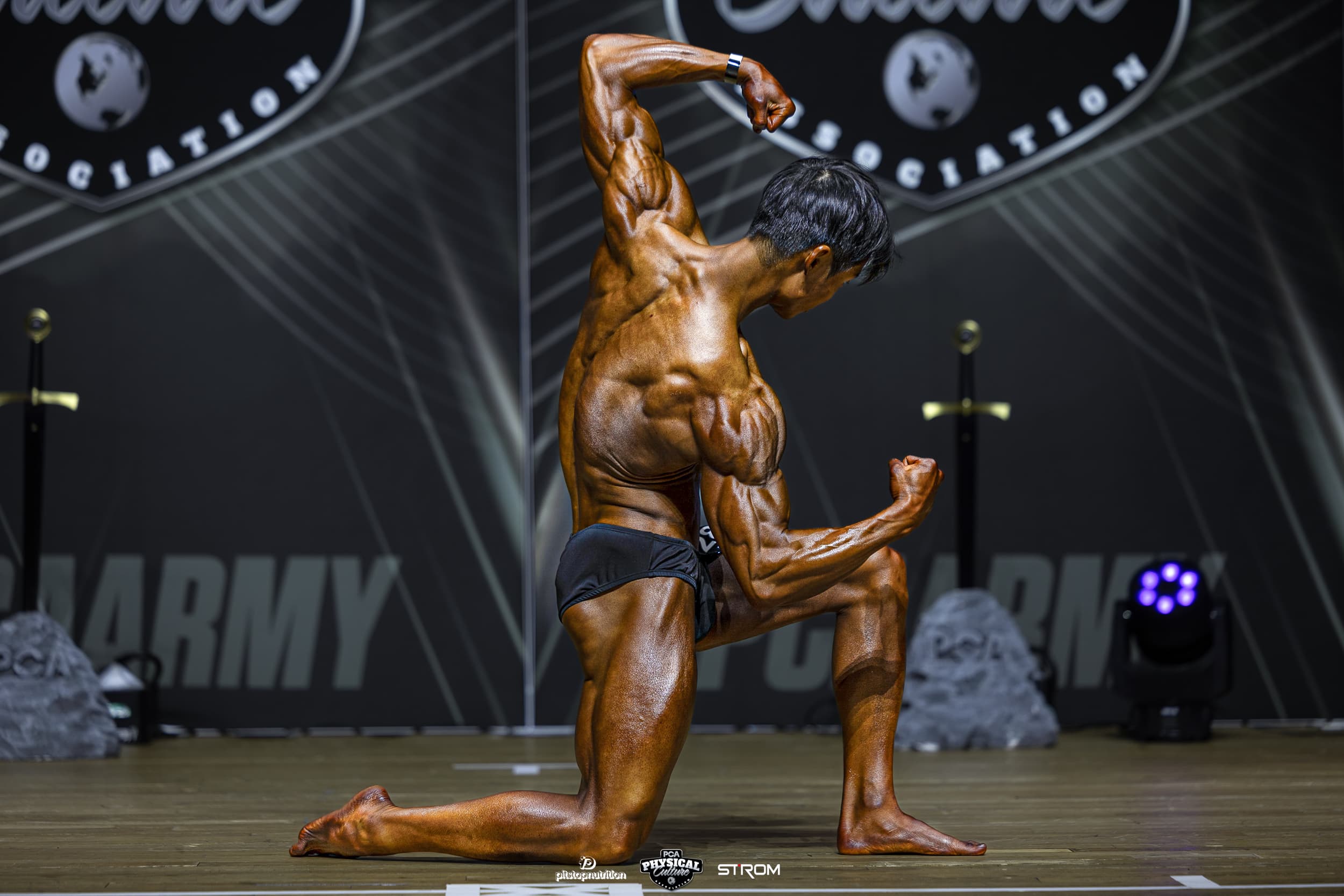 Vincent hitting a front pose on stage