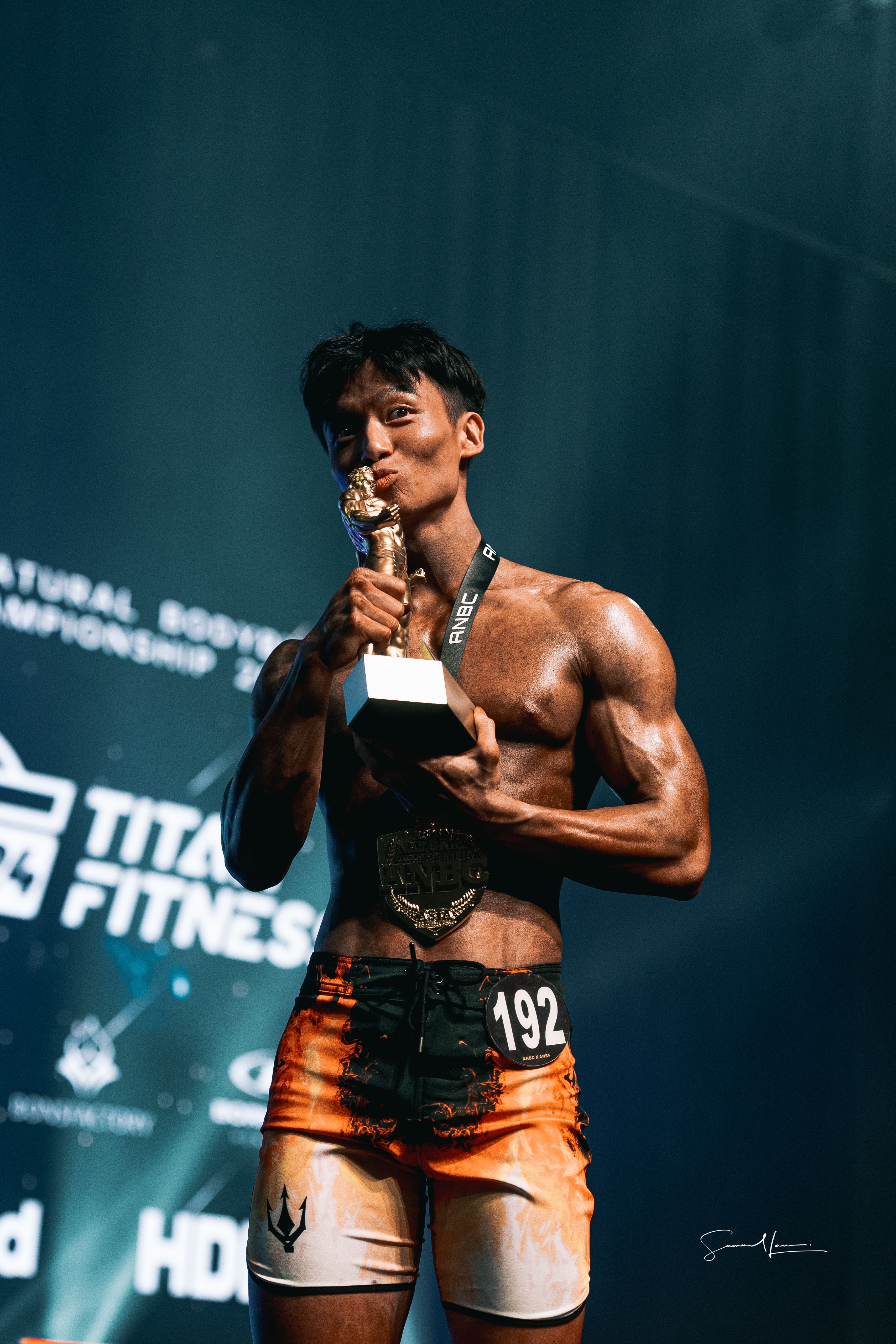 Vincent on stage with the ANBC junior Men's Physique trophy and champion's belt