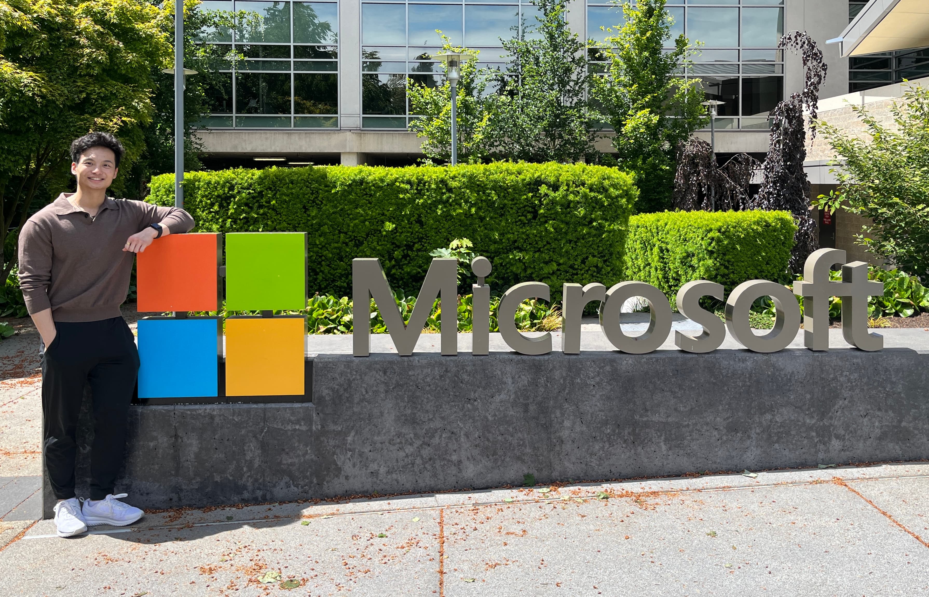 Vincent leaning on the Microsoft sign outside the campus